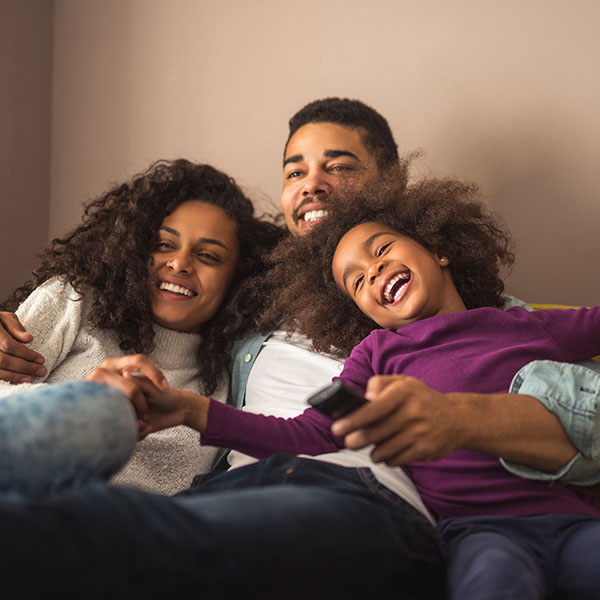 Family laughing on a couch